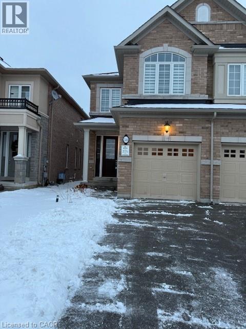A house with a garage and a driveway covered in snow.
