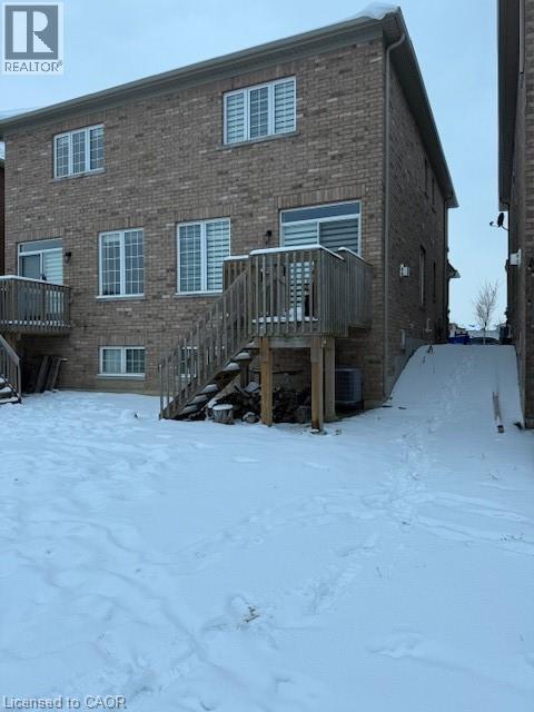 A snow-covered ground with a building in the background.