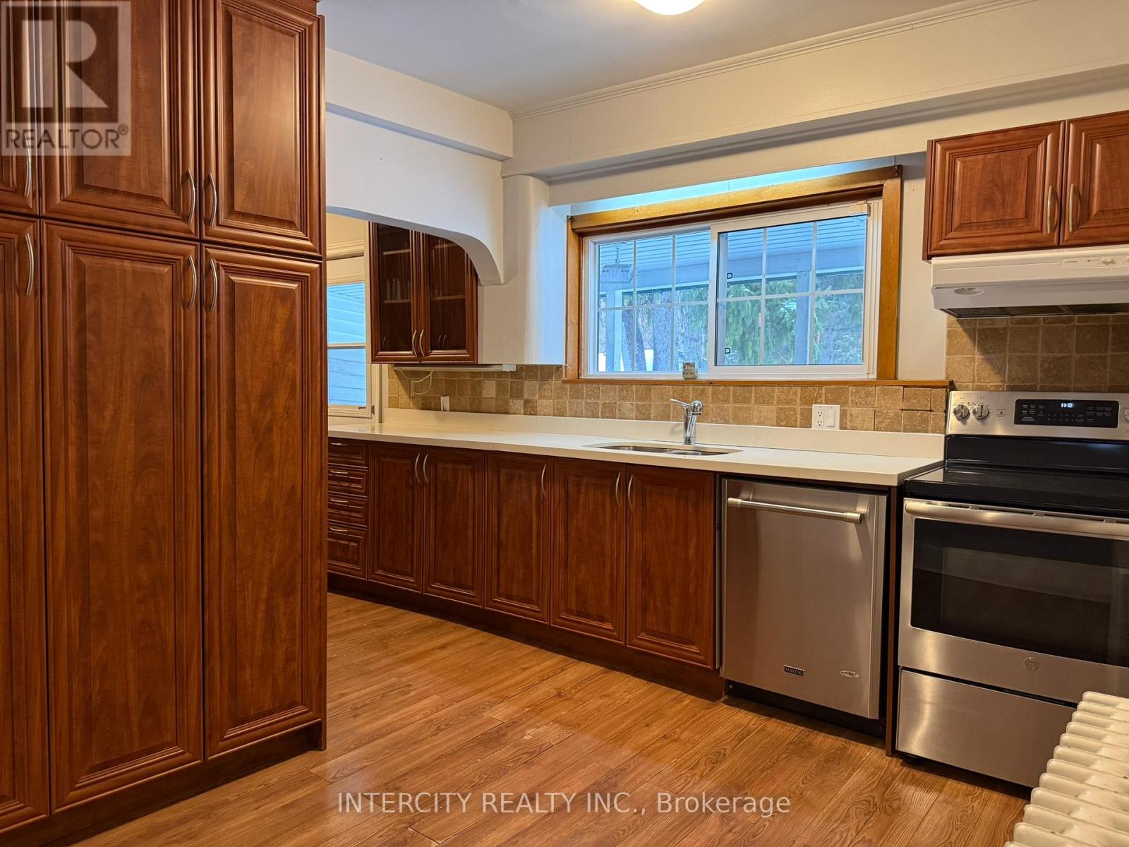 A kitchen with wooden cabinets and stainless steel appliances.