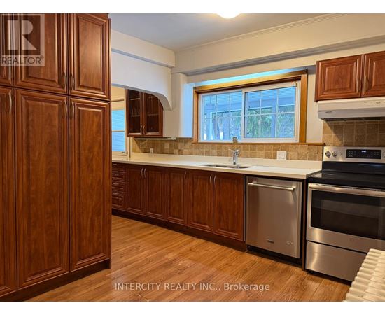 A kitchen with wooden cabinets and stainless steel appliances.