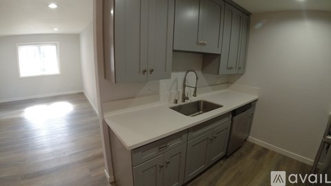 A kitchen with a sink and cabinets.