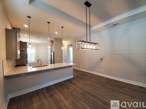 A modern kitchen with a long counter and a large island.