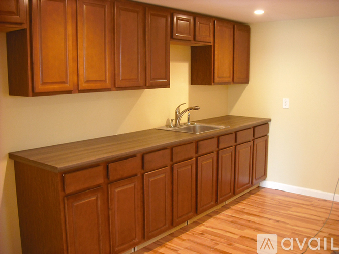 A kitchen with wooden cabinets and a countertop.