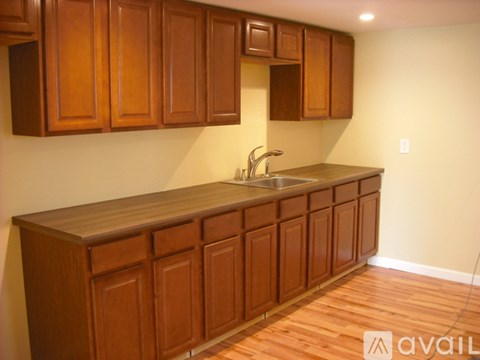 A kitchen with wooden cabinets and a countertop.