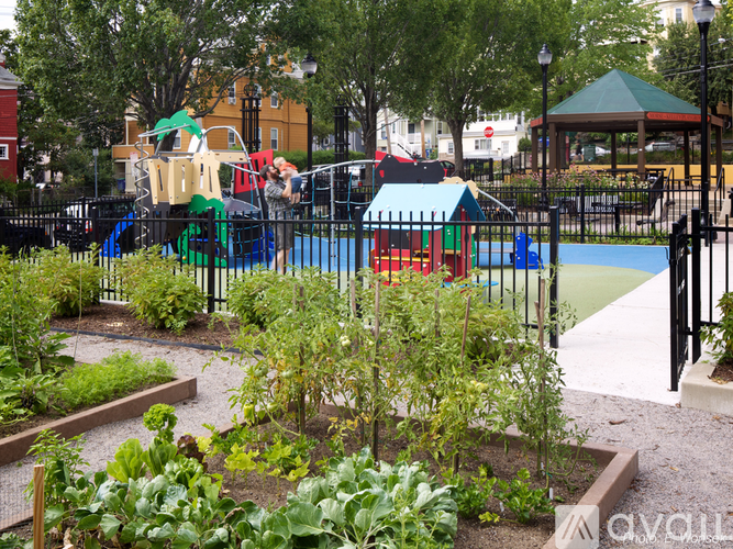 A playground with a slide, swings, and a playhouse.