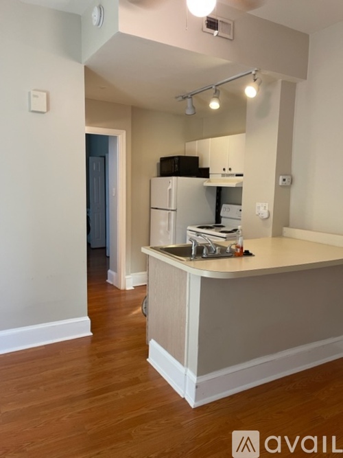 A kitchen with a counter and a sink.