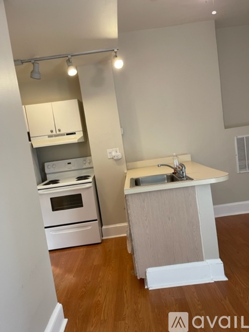A kitchen with a white oven and sink.