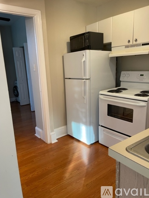 A kitchen with a white refrigerator, stove, and oven.