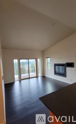 A living room with a television and sliding glass doors.