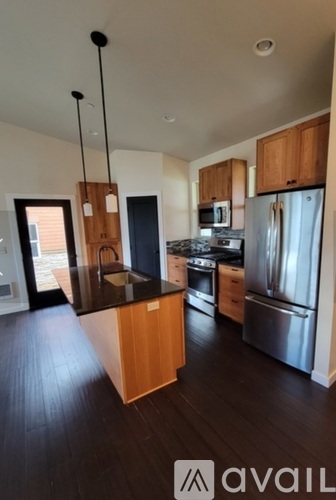 A kitchen with wooden cabinets and stainless steel appliances.