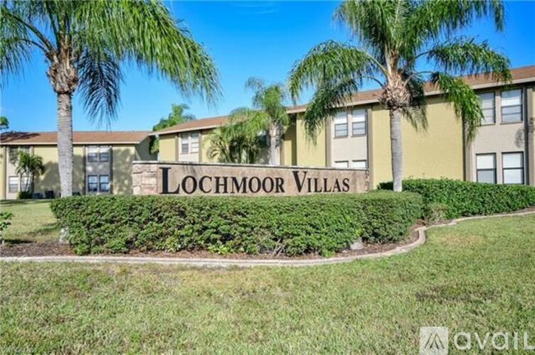 A sign that says Lochmoor Villas in front of some buildings.
