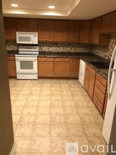 A kitchen with a white oven and microwave on top of it.