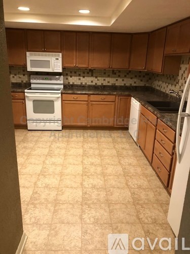 A kitchen with a white oven and microwave on top of it.