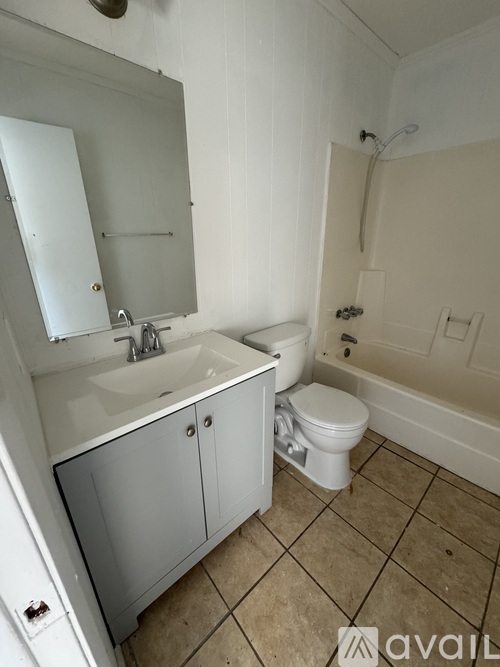 A bathroom with a sink, toilet and bathtub.