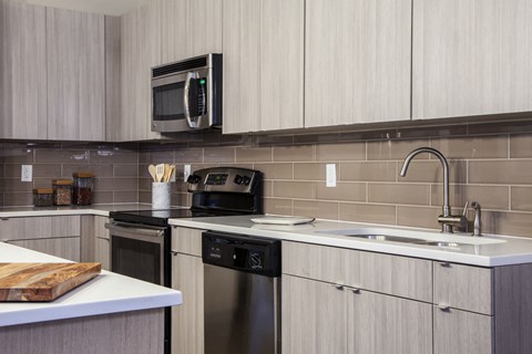 a kitchen with a sink and a stove and a microwave