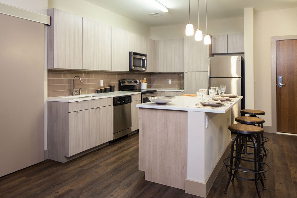 a kitchen with an island and stools
