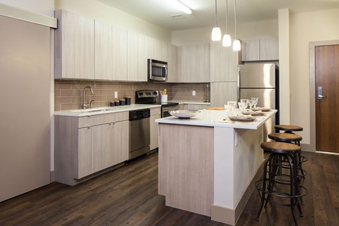 a kitchen with an island and stools