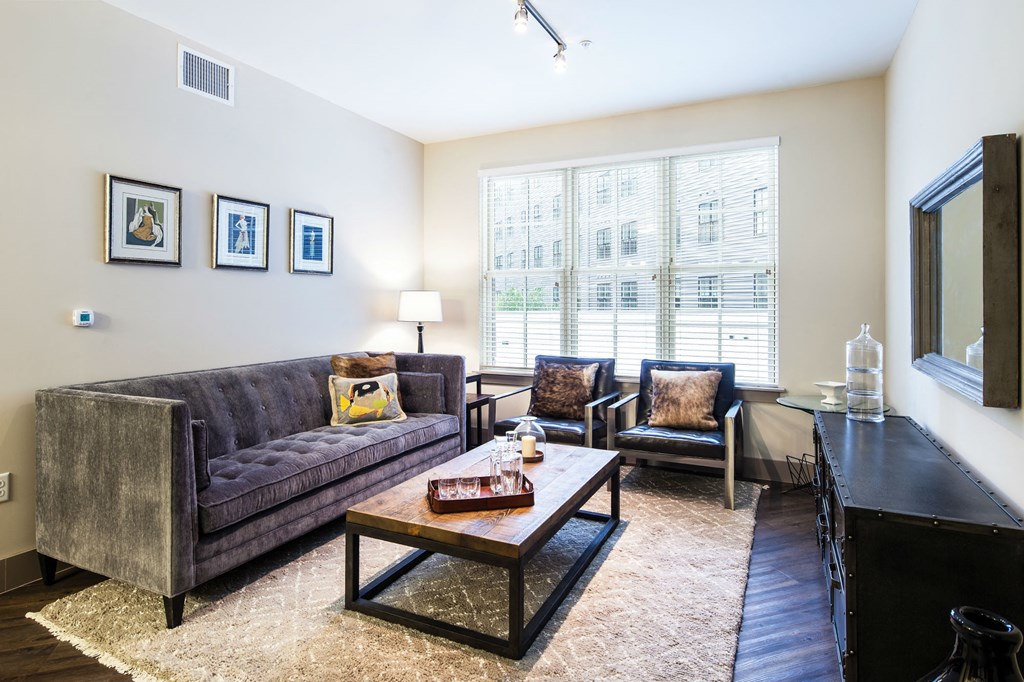 a living room with a couch and two chairs