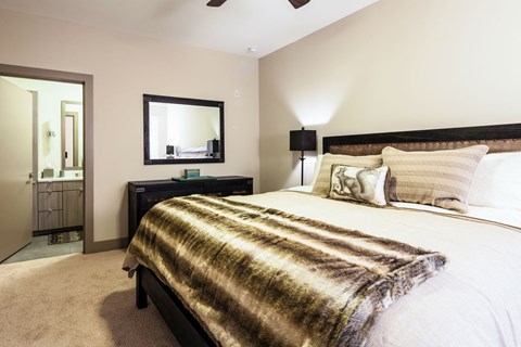 a bedroom with a bed and a mirror