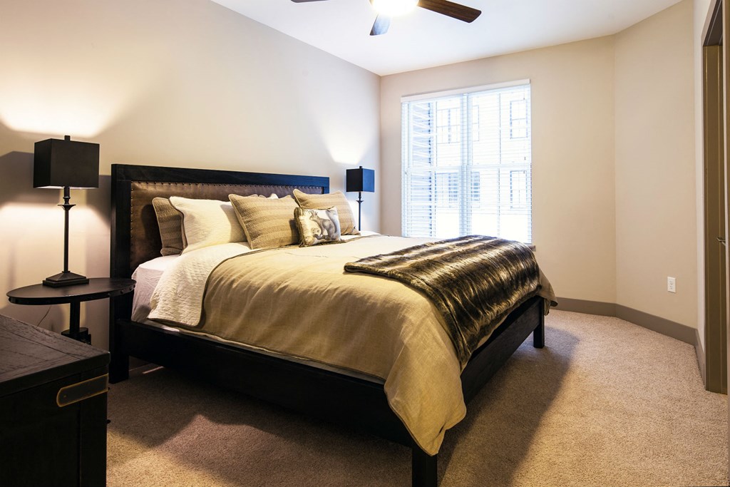 a bedroom with a large bed and a window