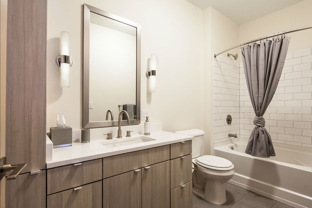a bathroom with a toilet sink and a mirror