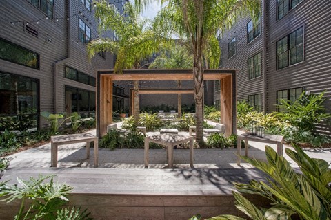 a courtyard with a table and chairs in front of a building