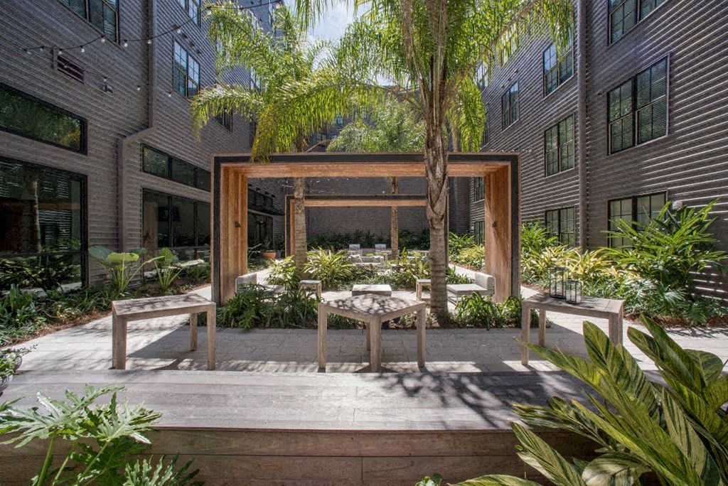 a courtyard with a table and chairs in front of a building