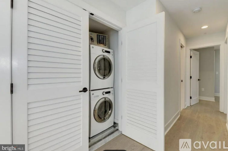 A white door with a washing machine inside it.