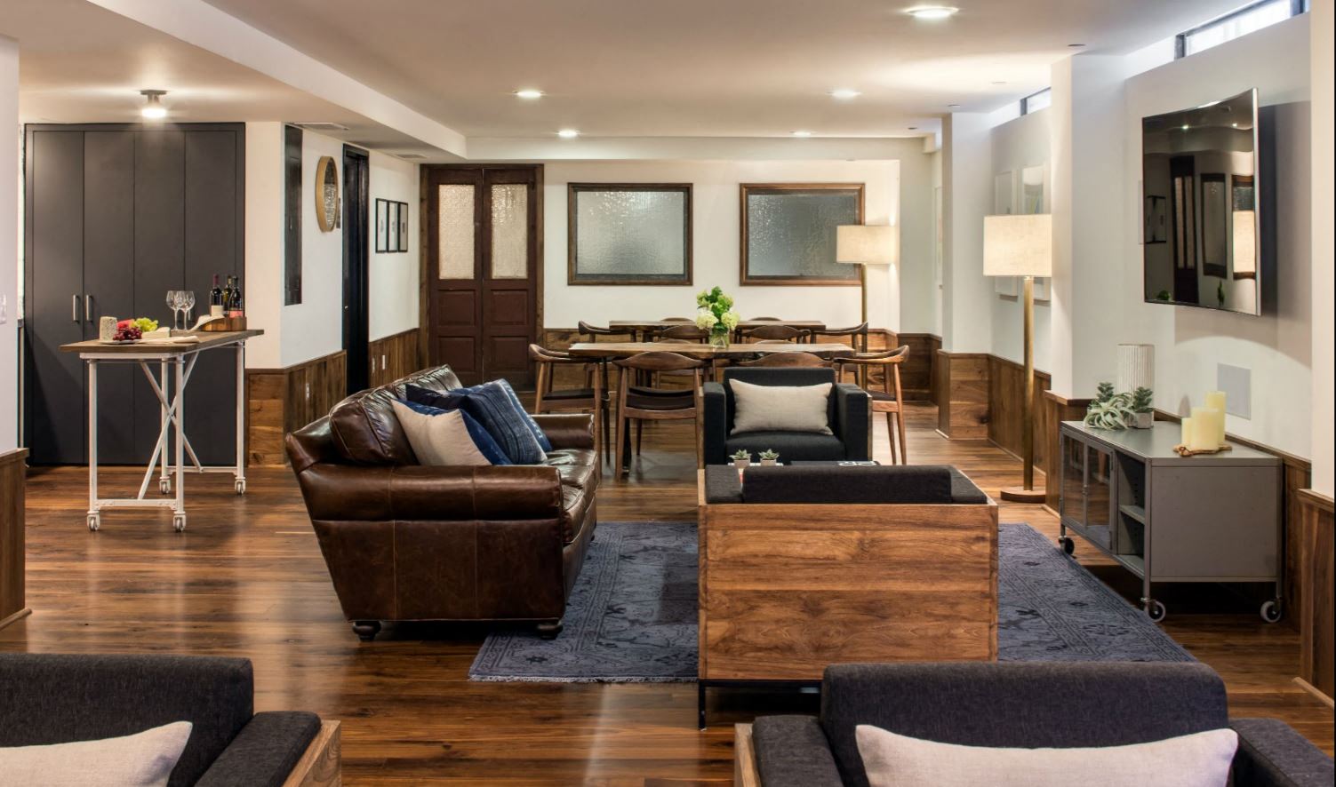 a living room filled with furniture and a dining room