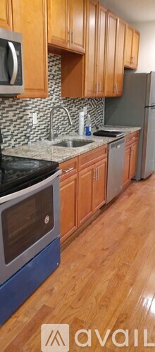 A kitchen with wooden cabinets and a black stove top oven.