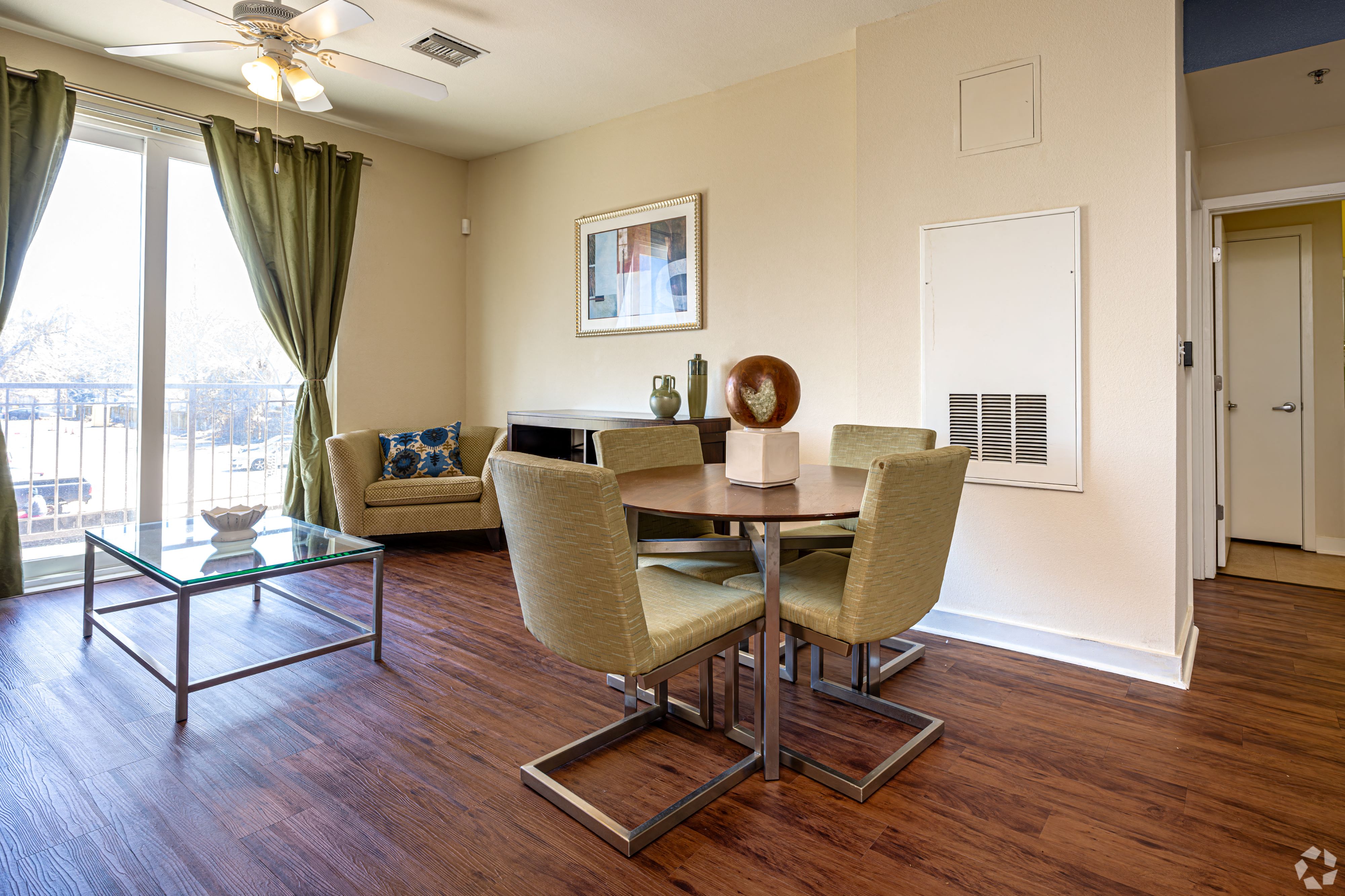 A dining room with a glass table and chairs.