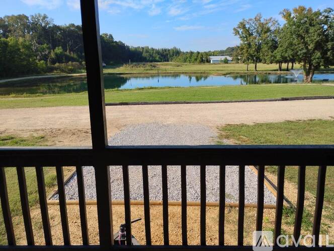 A view from a balcony looking out at a lake and trees.