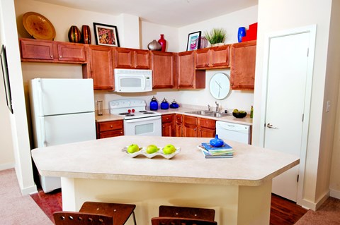 a kitchen with white appliances and wooden cabinets