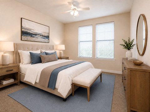A bedroom with a large bed and a painting on the wall.