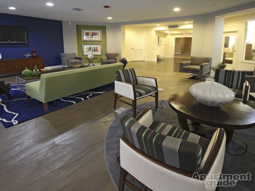 a large living room with a couch and chairs and a table