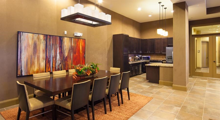 a dining room with a table and chairs