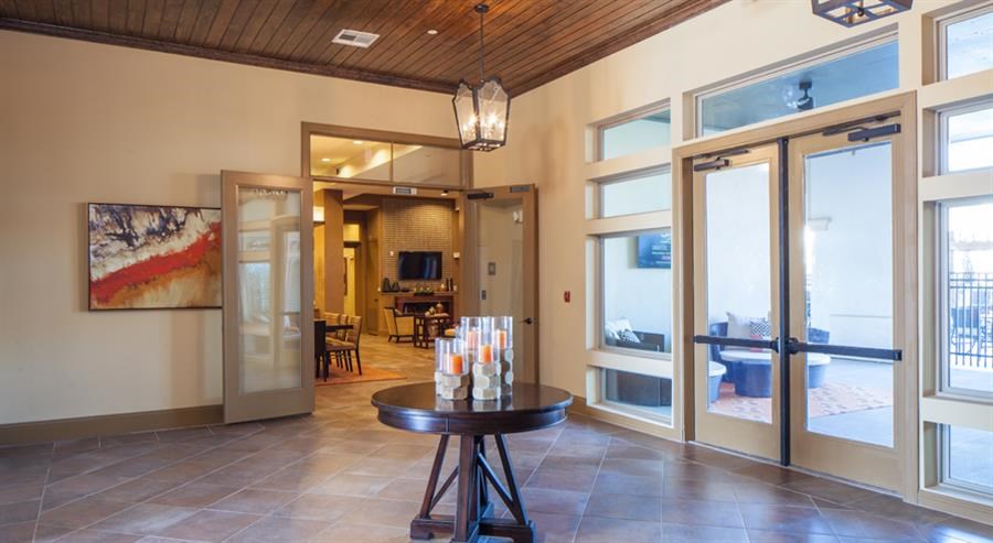 a living room with a table and some windows