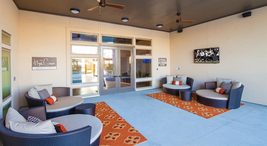 a living room with couches and chairs and a tv