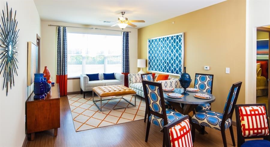 a living room and dining room with a table and chairs