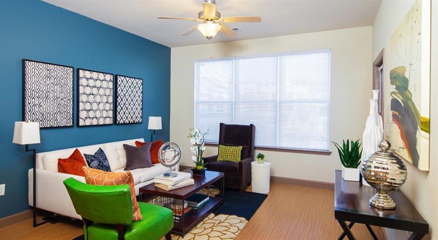 a living room with a blue wall and a white couch