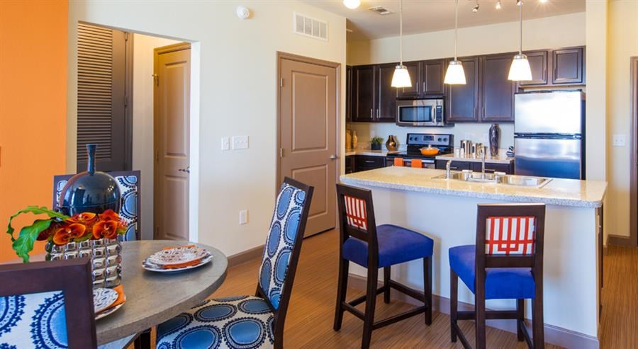 a kitchen and dining room with a table and chairs