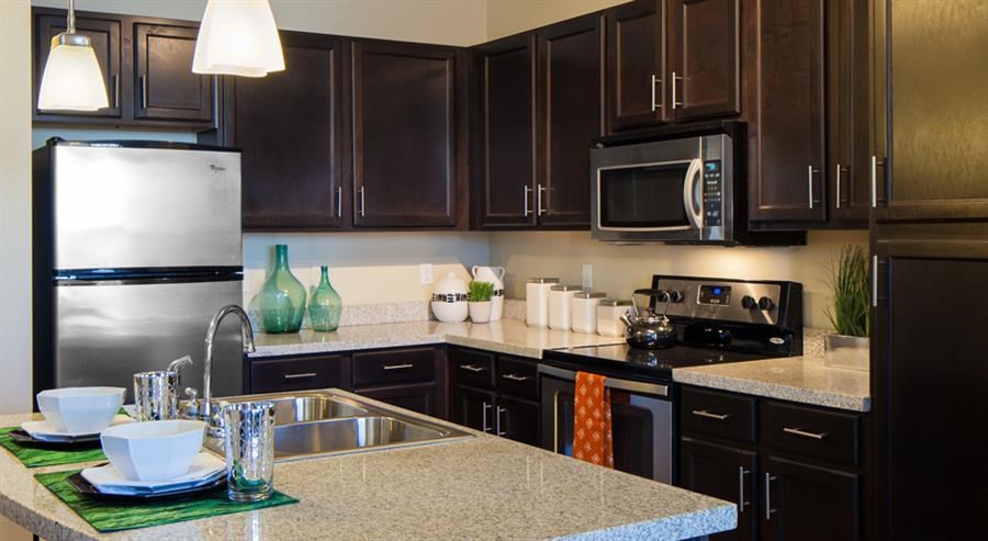 a kitchen with a sink a stove and a microwave