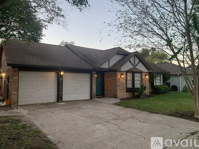 A house with a garage and a driveway is available for sale.