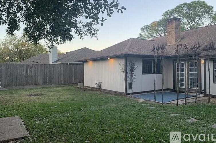 A house with a fence and a pool in the backyard.