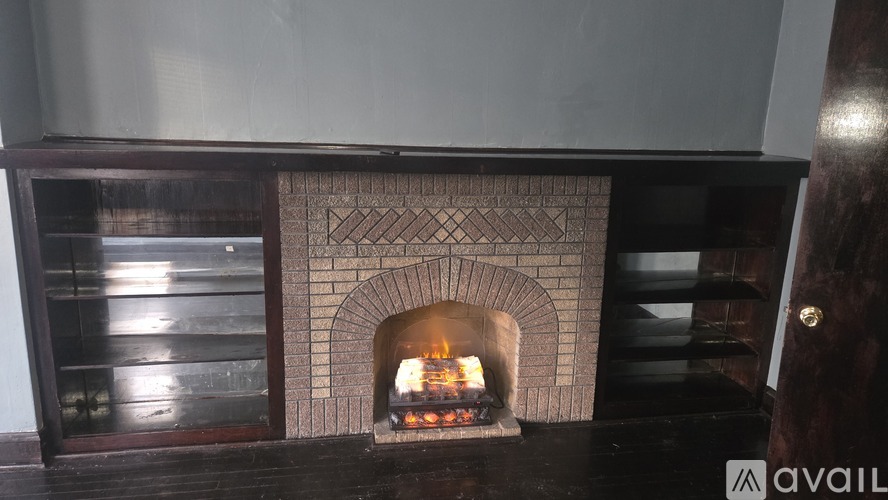 A fireplace with a fire burning inside.