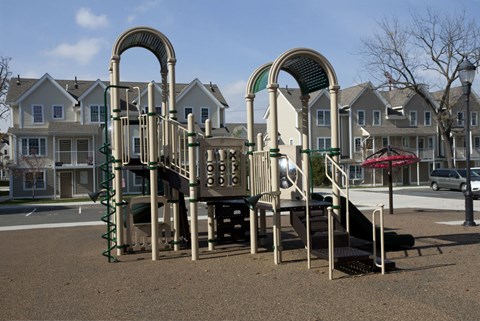 a playground in front of a row of houses