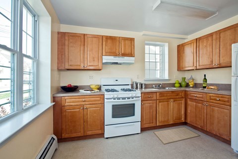 a kitchen with white appliances and wooden cabinets