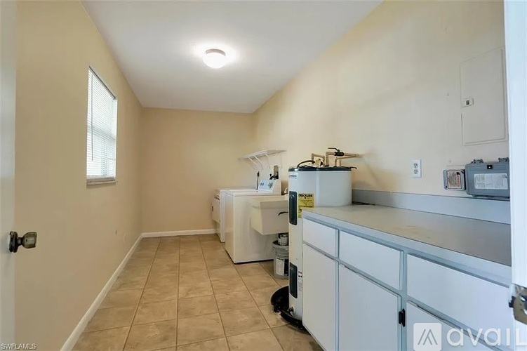 A long hallway with tiled floors and white walls.