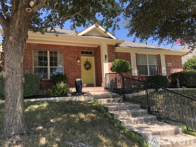 A house with a yellow door and a flag on the roof.