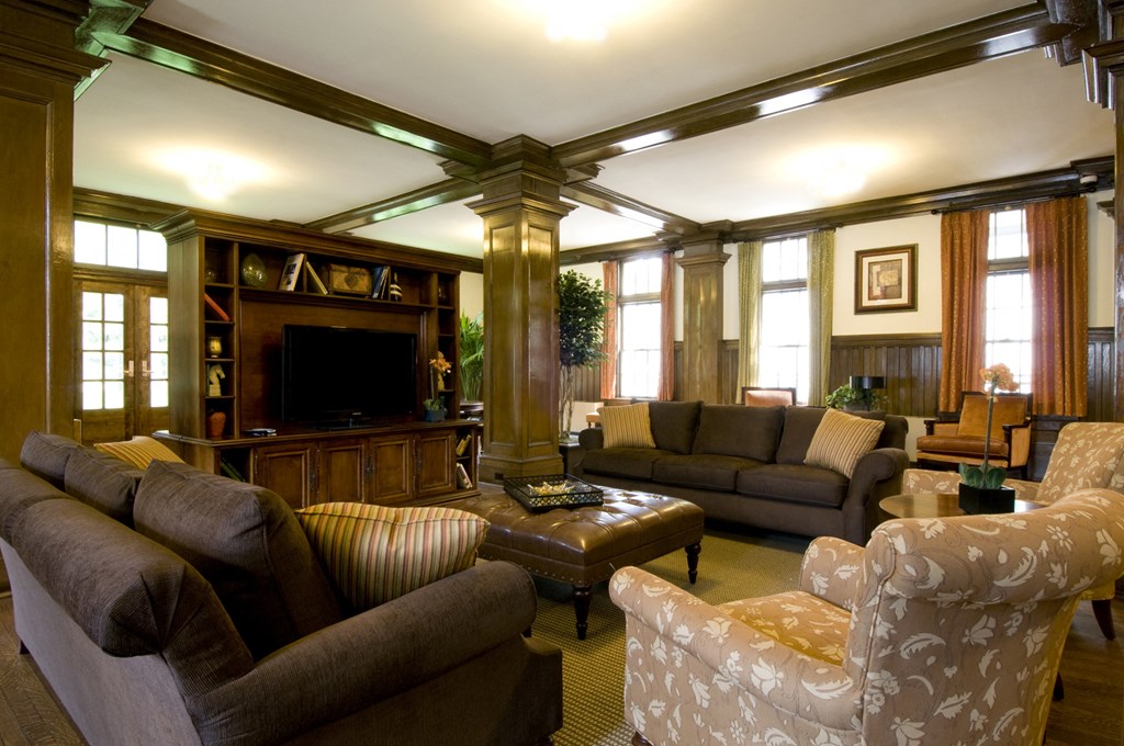 a living room with couches and chairs and a television